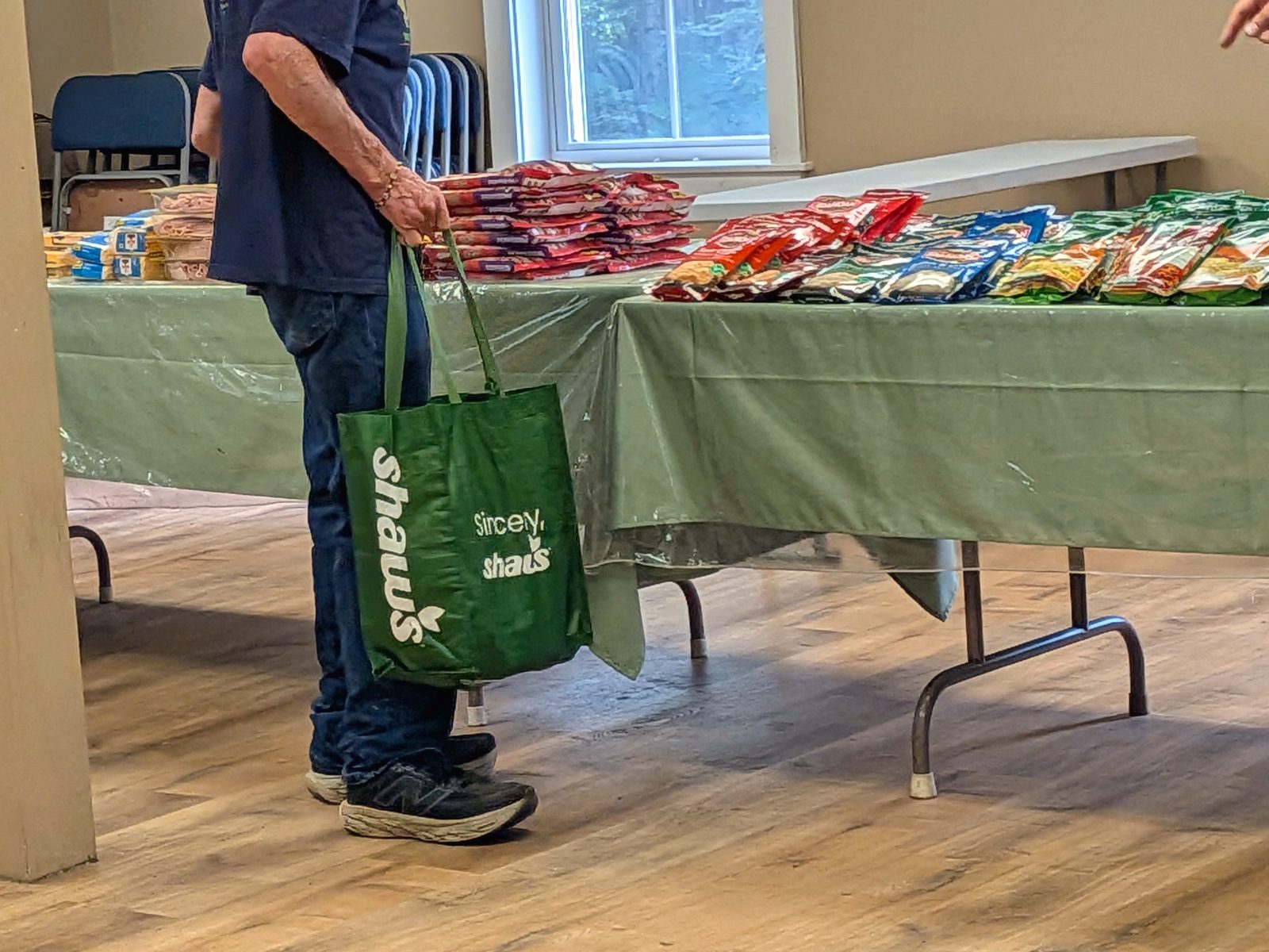 A neighbor collecting groceries at the monthly food distribution